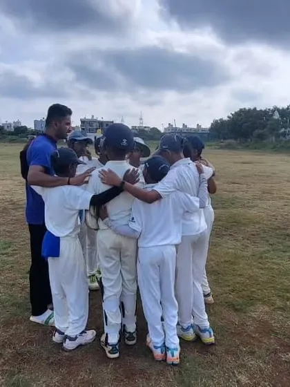 A team huddle with the coach during a break in play on the Hubli tour.