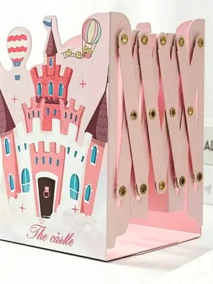 A fairytale-themed expandable bookend featuring a pink castle design. This metal book holder is sturdy and can be adjusted to hold a few or many books.