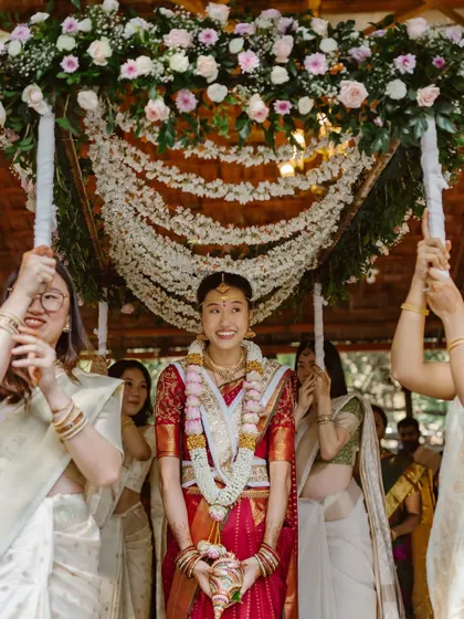 A bride's entrance should be nothing short of magical. For this South Indian wedding, we designed a breathtaking 'Phoolon ki Chadar' or floral canopy, creating a dreamy pathway for the bride as she was escorted by her loved ones.
