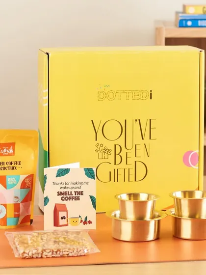 A coffee lover's dream, this gift box includes filter coffee decoction and traditional brass dabara sets for an authentic South Indian coffee experience.