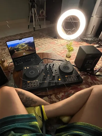 The behind the scenes of my living room studio. You can see my DJ console, laptop, speakers, and the ring light I use to film these sessions.
