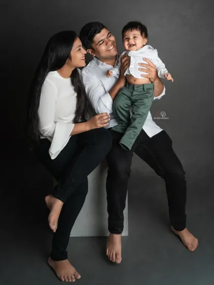 So much joy in one photo. The baby's big smile makes this family portrait even more special and full of life.