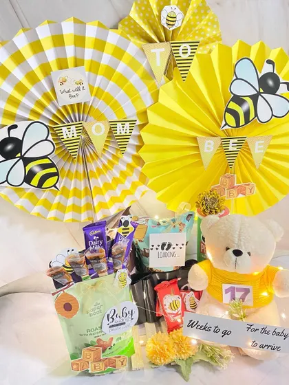 What will it bee? This jumbo "Mommy to Bee" hamper is buzzing with excitement, packed with snacks, a cute teddy bear, and a countdown tracker for the baby's arrival.