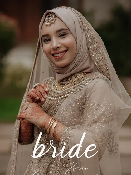 An elegant close-up portrait of a smiling Muslim bride, showcasing her beautiful makeup, jewelry, and bridal attire.