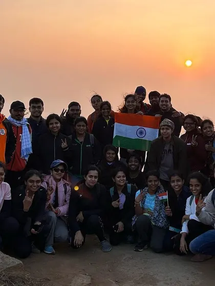 A proud Republic Day group photo with the Indian flag after our sunrise trek to Huthridurga.