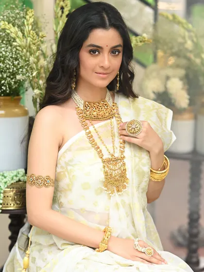 A beautiful portrait of actress Darshana Banik from her Sananda magazine shoot. The composition is clean and elegant, focusing on her and the exquisite gold jewellery.