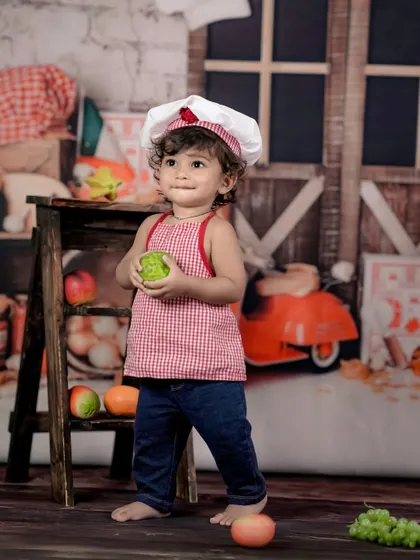 A curious little chef exploring the ingredients in his kitchen. We love capturing these candid moments of play.