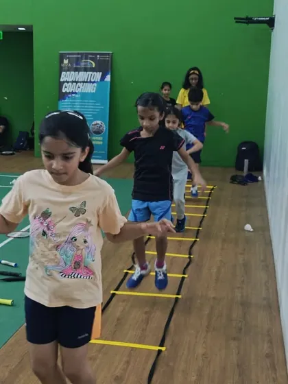 Agility is key in badminton. Here, my young students work on their footwork and coordination using agility ladders, a fun and essential part of our fitness routine for kids.