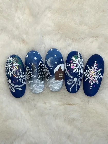 A top-down view of the detailed Christmas landscape nail art. This is a great example of storytelling through nail design.