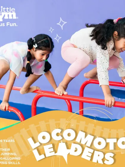 Two girls practice their form on the parallel bars. This activity helps our 'Locomotor Leaders' refine their coordination and build strength while learning to work alongside their peers.