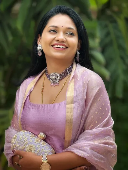 A close-up portrait showing the details of my jewelry and the simple elegance of the outfit.