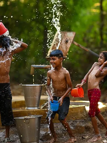 A moment of pure chaos and fun as water flies in every direction. The smiles on the children's faces show the simple happiness found in beating the summer heat together.