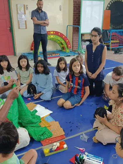 I am showing the students how to drape a saree on a puppet. It is a great way to teach them about both puppetry and Indian culture.