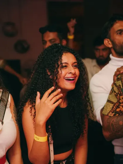 A huge smile from a happy partygoer.