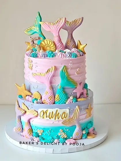 A full view of the two-tier pastel mermaid cake for Kuha's 5th birthday. The soft colors and shimmering details create a fairytale look that's perfect for a little one who loves the ocean.