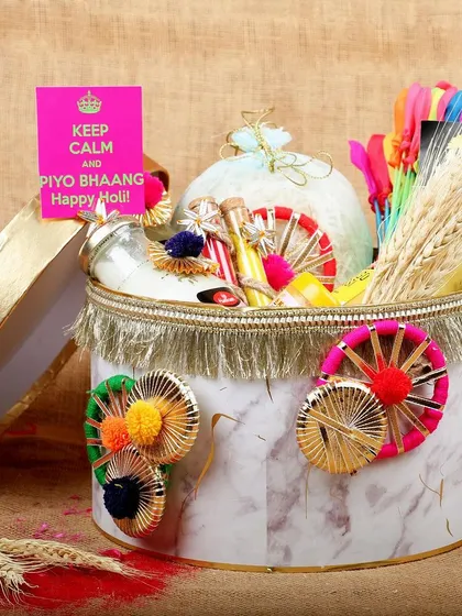 An elegant Holi gift box, showcasing a curated selection of items for a luxury gifting brand's festive collection.