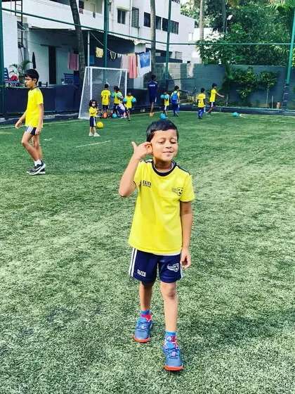 A player poses with a cool gesture, showing his personality and confidence. We encourage our players to express themselves.