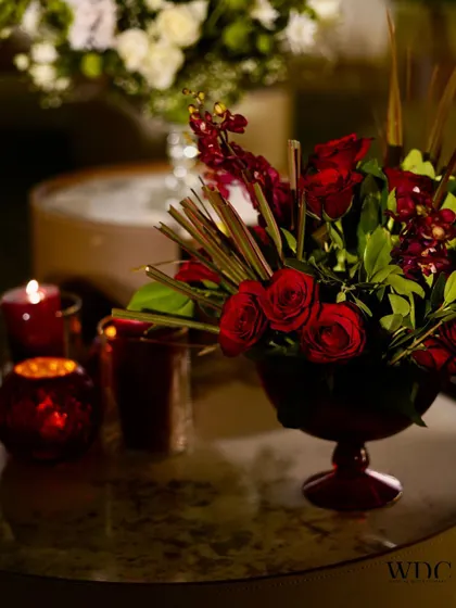 Whispers of romance and candlelit elegance. Nothing speaks the language of love like deep red roses and the warm glow of candles, creating a timeless and sophisticated atmosphere.