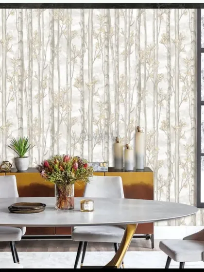 A dining room featuring a subtle, light-colored wallpaper with a birch tree pattern.