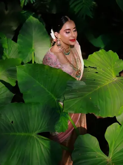 This artistic shot captures the essence of a soft and natural engagement look. The makeup was completed in just one hour, focusing on a dewy, glowing finish that enhances the bride's natural radiance, perfect for an outdoor setting.