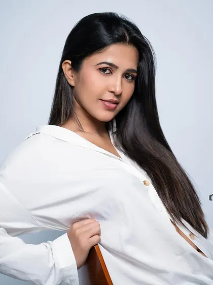 A classic, clean headshot with a simple white shirt.