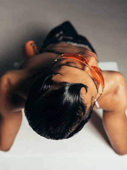 An overhead shot that offers a unique perspective on the model and styling. This artistic composition is designed to be visually disruptive and engaging.