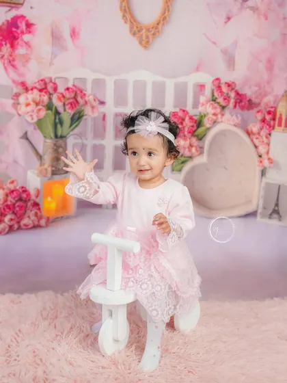 A bubble adds a touch of magic to this pretty-in-pink milestone session. This little girl is enjoying the playful atmosphere.