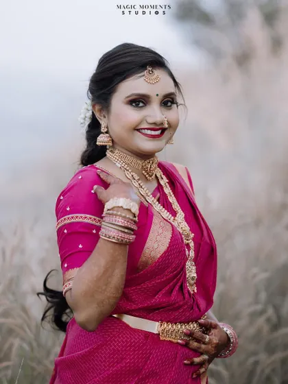 A beautiful close up portrait of the bride, Muduganga, during her engagement photoshoot. Her bright smile and traditional attire are the focus.