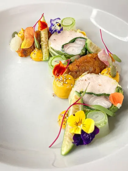 A dish that is as vibrant as it is flavorful. This Ballotine of fish is wrapped in Swiss Chard with a shrimp mousseline, complemented by yuzu pumpkin and pickles. It’s a perfect example of my approach to fine French cooking.