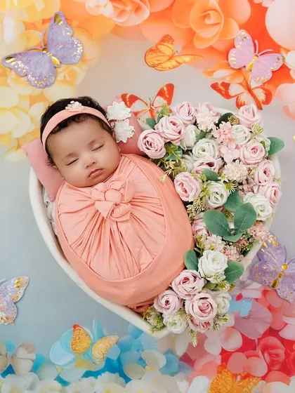 Capturing the peaceful perfection of a newborn. This little one, nestled in a heart of flowers, showcases the delicate, artistic, and safe approach I take for my newborn photoshoots, creating a timeless piece of art.