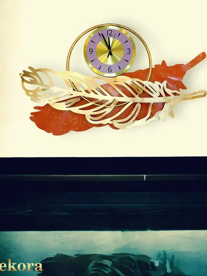 Another view of our red and gold feather clock, a small but vibrant piece of functional decor.