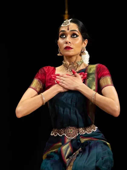 A moment of deep emotion and storytelling (abhinaya) during a performance. The eyes and hands work together to convey the narrative to the audience.