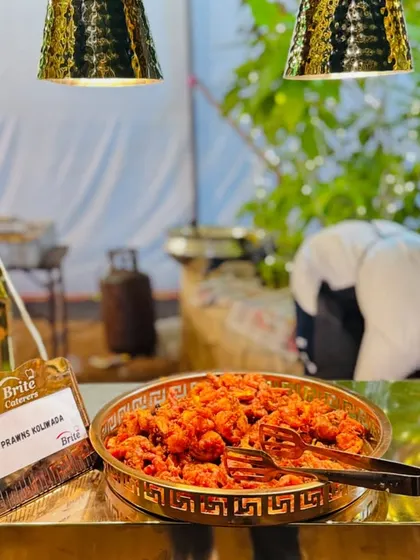 A bowl of Prawns Koliwada presented on an elegant, modern stand.