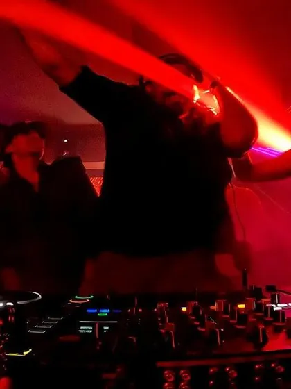 The whole crew raising their hands behind the decks. The collective energy is what makes these nights special.