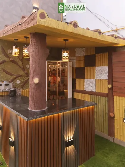 The custom-designed outdoor bar at our Shahdara site. The unique design features a tree-like support column and a mix of textured materials.