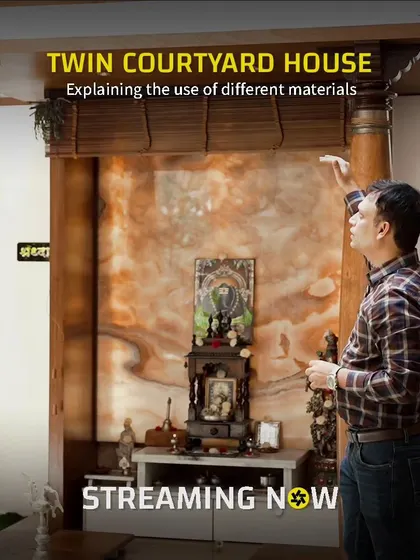 This image captures our architect explaining the material palette of the pooja room. We believe in using materials thoughtfully to evoke the right emotion, and here, wood and onyx create a sense of warmth and divinity.