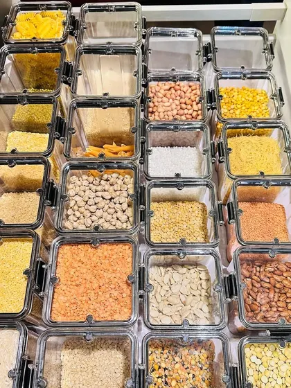 How satisfying is this? Using uniform, transparent containers in a drawer gives you a top-down view of all your grains and pulses, making inventory a breeze.