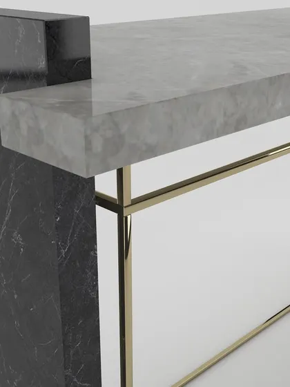 A close-up of the junction between the grey marble top, black marble leg, and the thin metal frame, highlighting our precision craftsmanship.