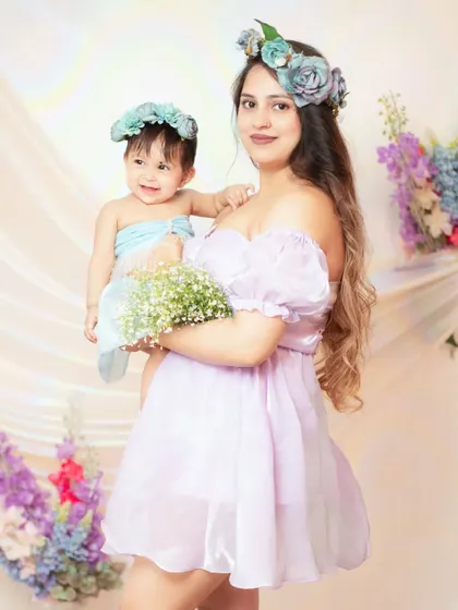 A mother and daughter share a moment in our floral-themed setup, perfect for our special Mother's Day mini sessions.