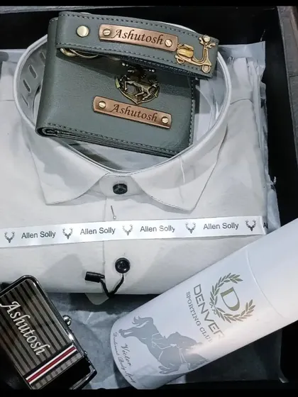 This premium gift hamper includes a personalized wallet, keychain, and belt, along with a branded shirt and deodorant.