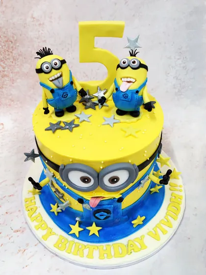 We turn up the fun with this 3D Minions cake, designed to look like one of the mischievous characters. Topped with two more playful Minions, this bright yellow cake is full of personality and is a fantastic, immersive centerpiece for a themed birthday party.