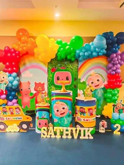 A vibrant Cocomelon theme for a second birthday. The setup is packed with color, characters, and a light-up number '2' to mark the special milestone.