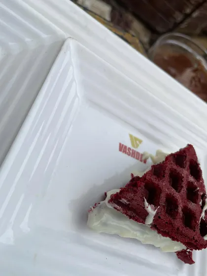 A close-up of our popular Red Velvet waffle with white chocolate cream. This single serving highlights the quality and visual appeal of our dessert offerings.