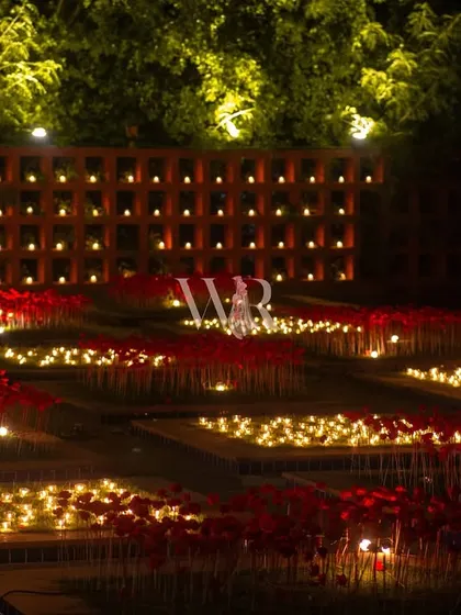 The full view of the garden installation, a key feature of the Sufi night. The combination of the candle wall and the glowing fields of red creates an immersive and unforgettable experience for guests.