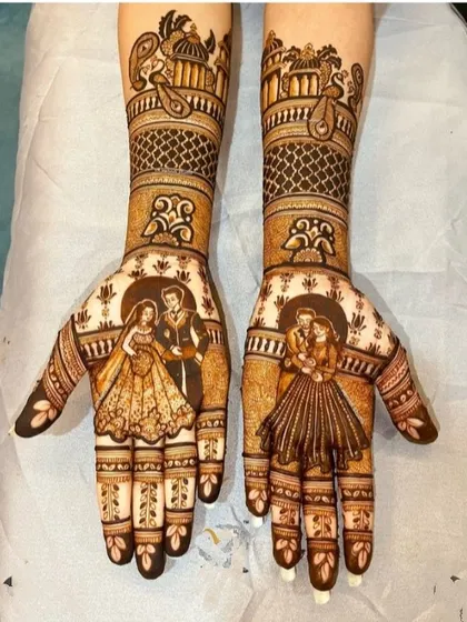 This design captures two special moments for the couple. The palms feature their romantic portraits, while the forearms include traditional Rajasthani palace motifs.