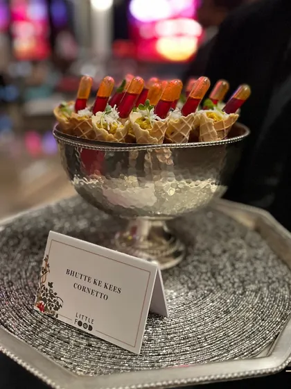 Our creative Bhutte Ke Kees Cornetto, a savory corn delicacy served in a mini cone, is a highlight of our festive menu. It's an innovative and delicious bite that always delights guests at Diwali parties.