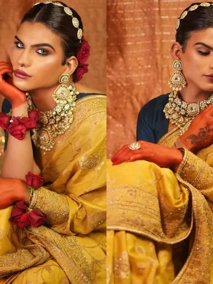 A unique and artistic take on a traditional look, featuring a model with henna-stained hands and bold, expressive makeup.