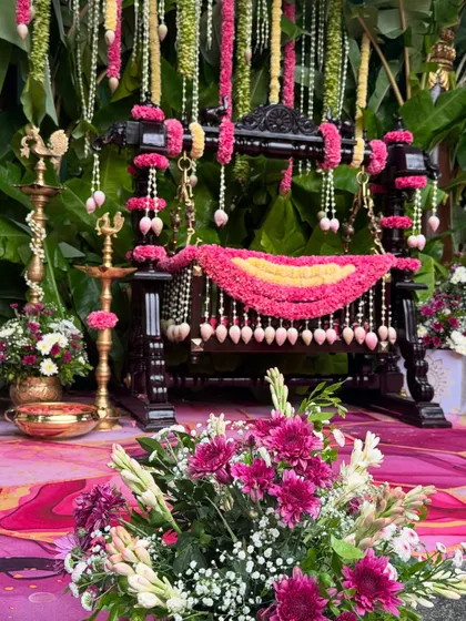 The beautifully decorated floral cradle (thottil) is the centerpiece of this traditional naming ceremony.