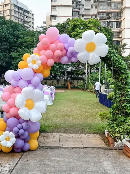 We created this vibrant, full-sized balloon arch to serve as a magical entrance for an outdoor garden party. The design features a pastel rainbow of balloons accented with large and small daisy foil balloons, perfectly framing the venue entryway.