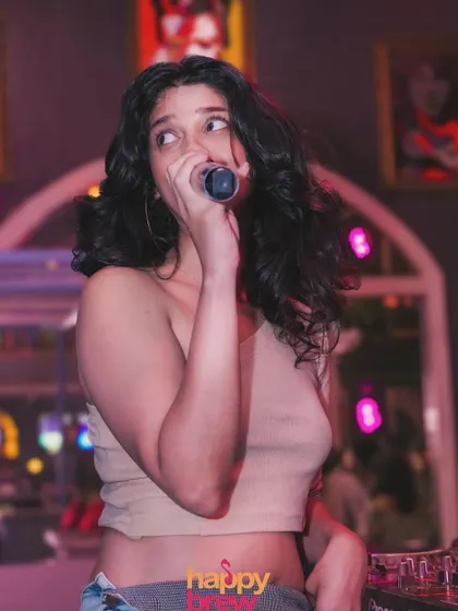 A candid moment while hosting a karaoke night. I love interacting with the crowd and making everyone feel involved.